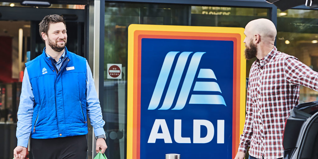 Aldi employee helping customer take shopping to their car